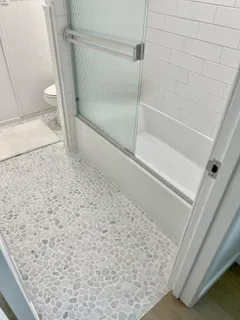 a bathroom with a sink a mirror and potted plant