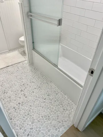 a bathroom with a sink a mirror and potted plant