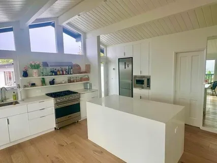 a kitchen with stainless steel appliances granite countertop a sink and a stove