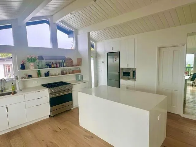 a kitchen with stainless steel appliances granite countertop a sink and a stove