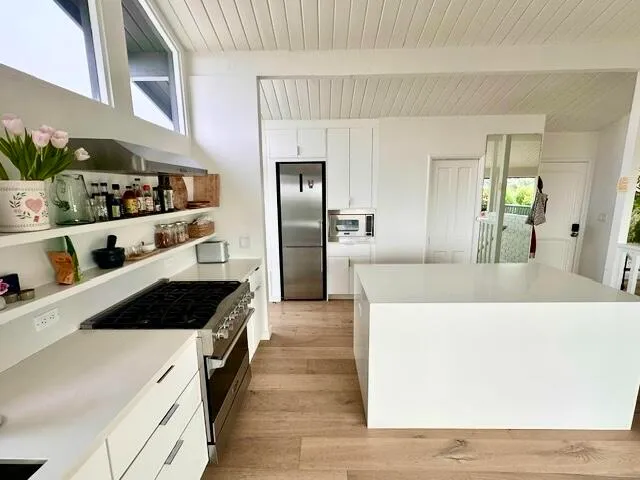 a kitchen with granite countertop cabinets and refrigerator