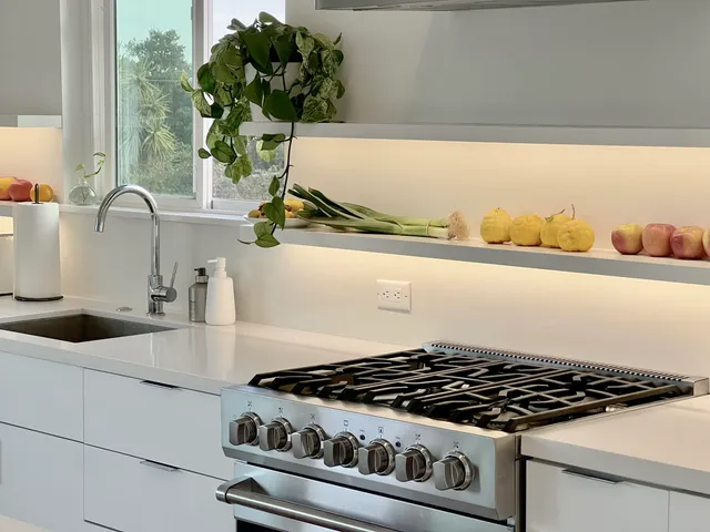 a close view of a stove a sink and a microwave