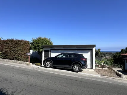 a view of a car parked in front of a house