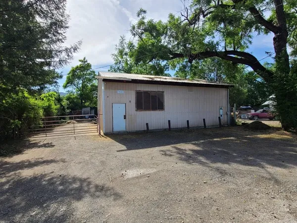 a backyard of a house with plants and trees
