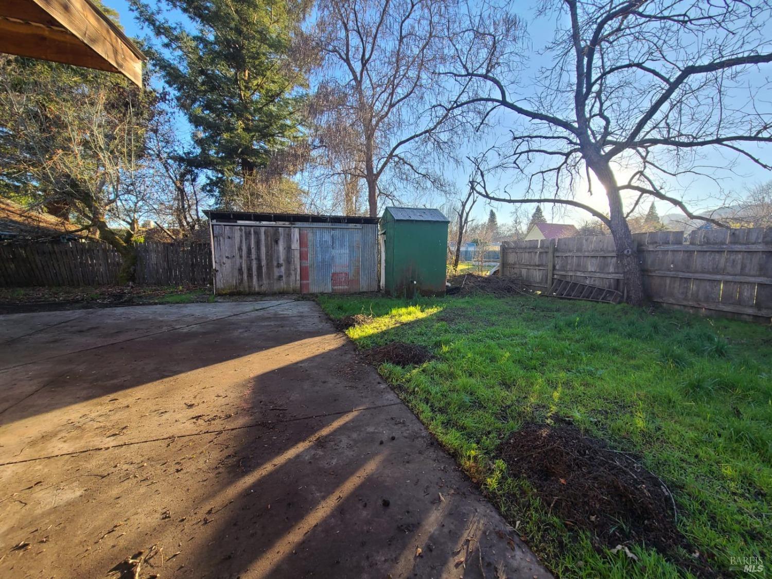 76440 Covelo Road Covelo, CA 95428 - Photo 14 of 19 a view of a backyard with large trees and wooden fence
