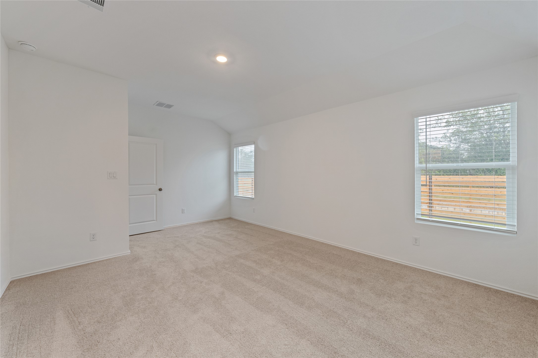 115 Parsons Kyle, TX 78640 - Photo 5 of 18 A spacious, naturally illuminated room features plush carpeting and multiple windows for abundant light.
