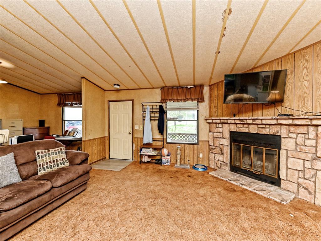 148 River Road Liberty Hill, TX 78642 - Photo 11 of 22 a living room with furniture a flat screen tv and a fireplace