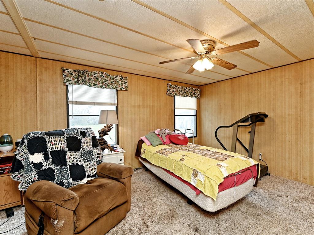 148 River Road Liberty Hill, TX 78642 - Photo 18 of 22 a bedroom with a bed couch and window
