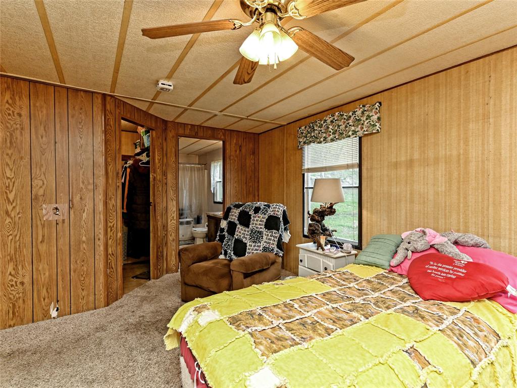 148 River Road Liberty Hill, TX 78642 - Photo 19 of 22 a bed room with a bed and a chair