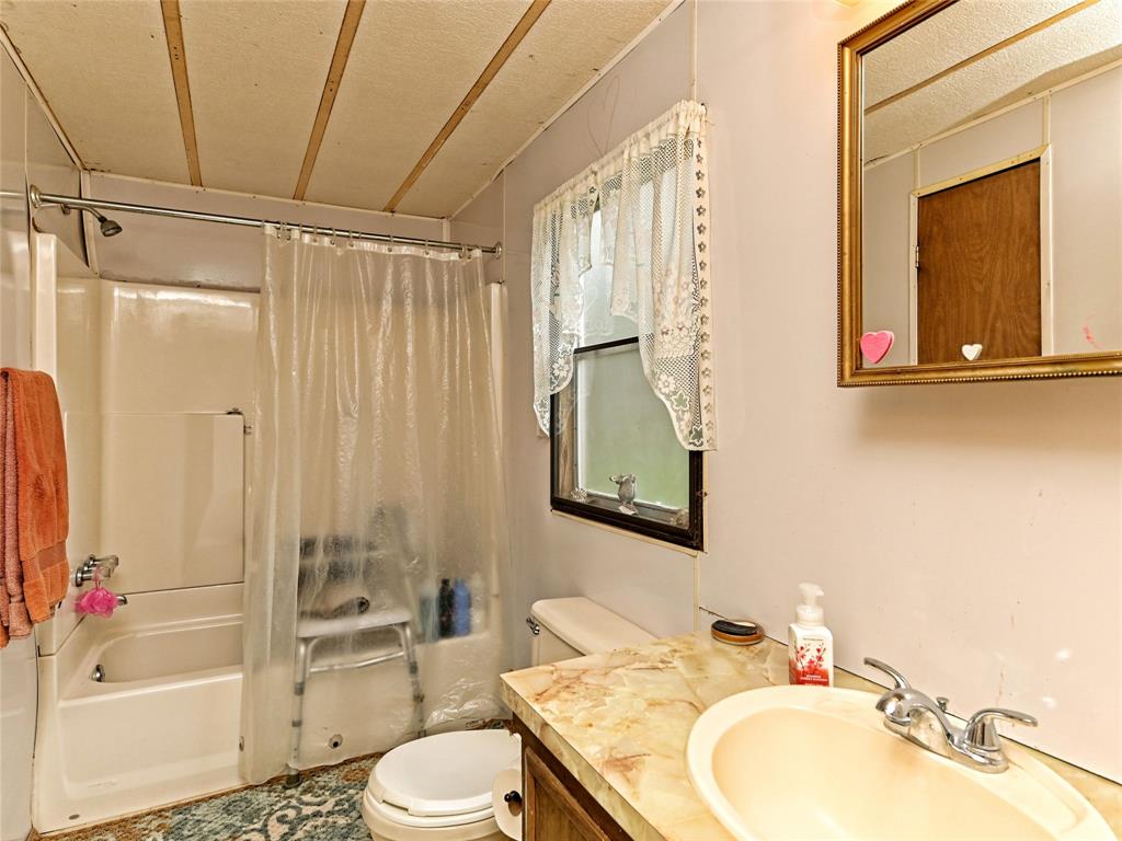 148 River Road Liberty Hill, TX 78642 - Photo 20 of 22 a bathroom with a sink toilet and shower