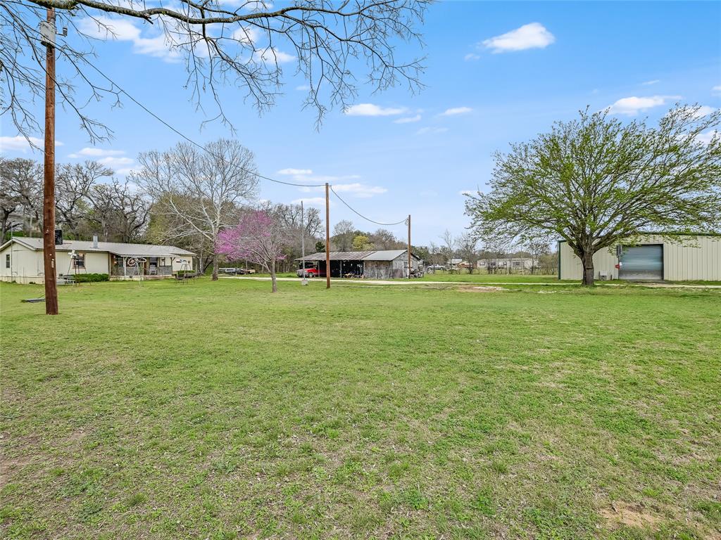 148 River Road Liberty Hill, TX 78642 - Photo 2 of 22 a view of yard with outdoor seating and covered with trees