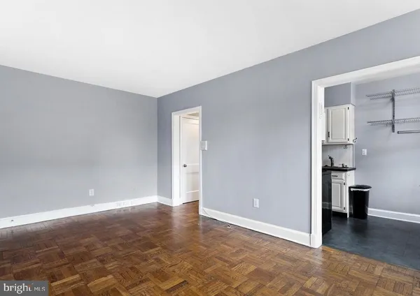 a view of a room with furniture and wooden floor