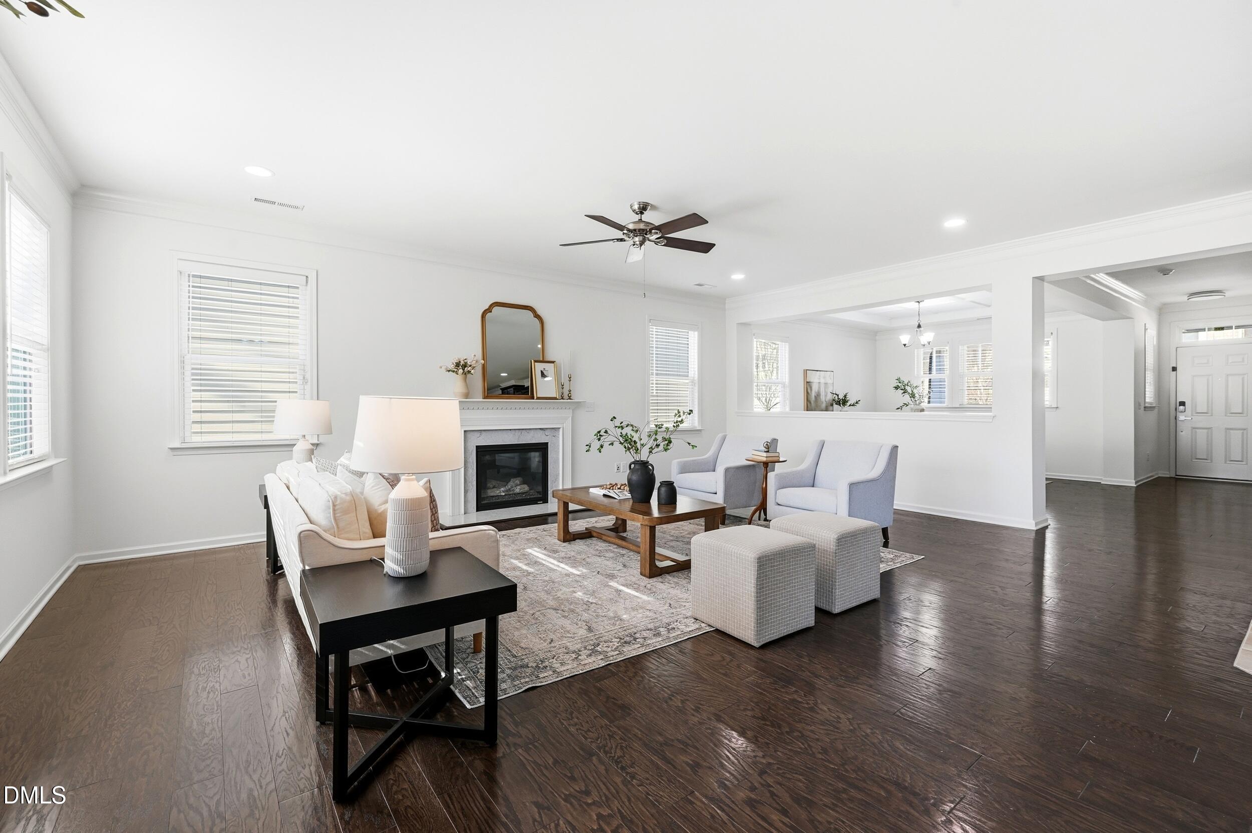 1037 Bender Ridge Drive Morrisville, NC 27560 - Photo 11 of 48 a living room with furniture a fireplace and a table