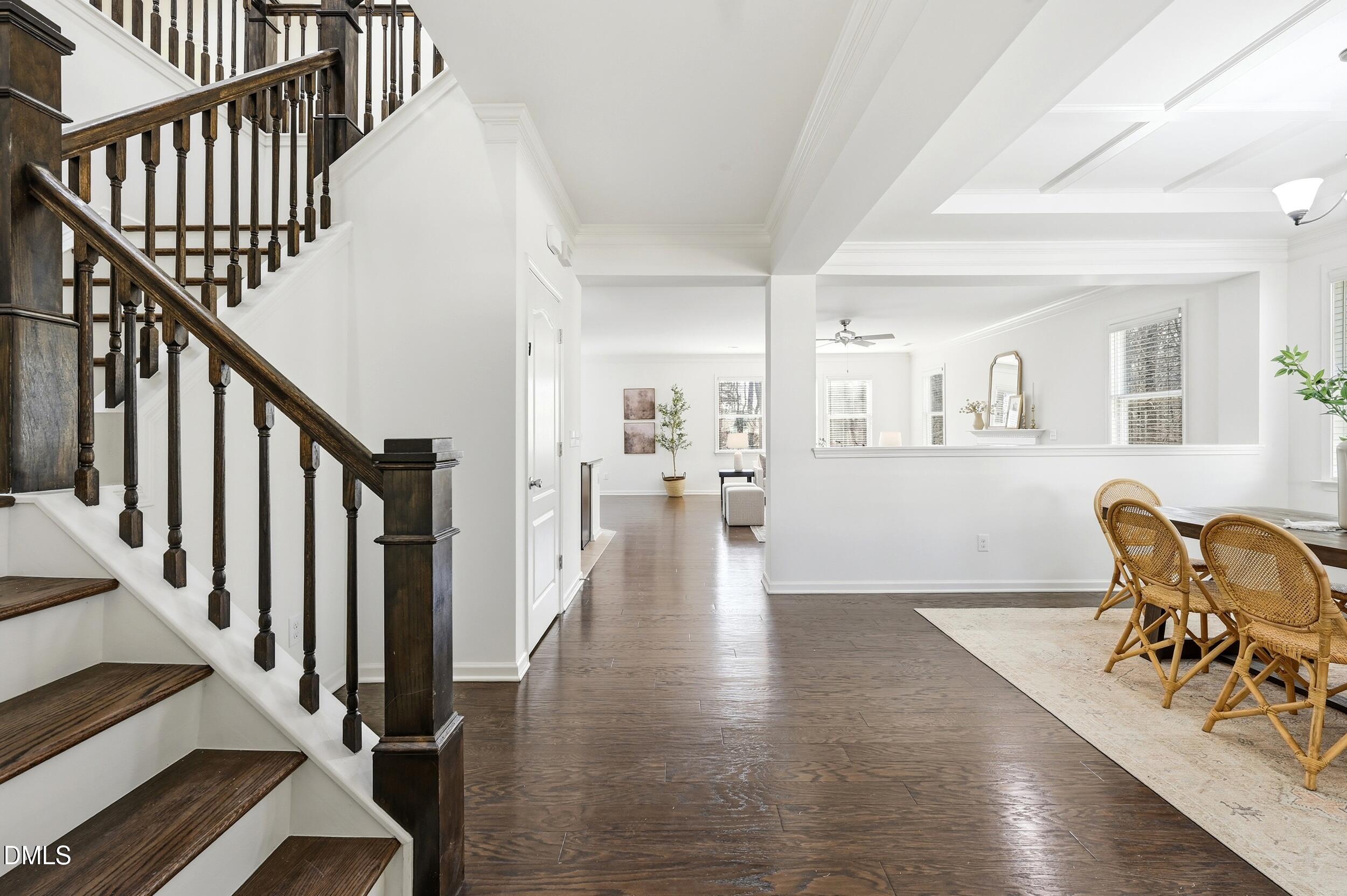 1037 Bender Ridge Drive Morrisville, NC 27560 - Photo 5 of 48 a view of a hallway with wooden floor and stairs