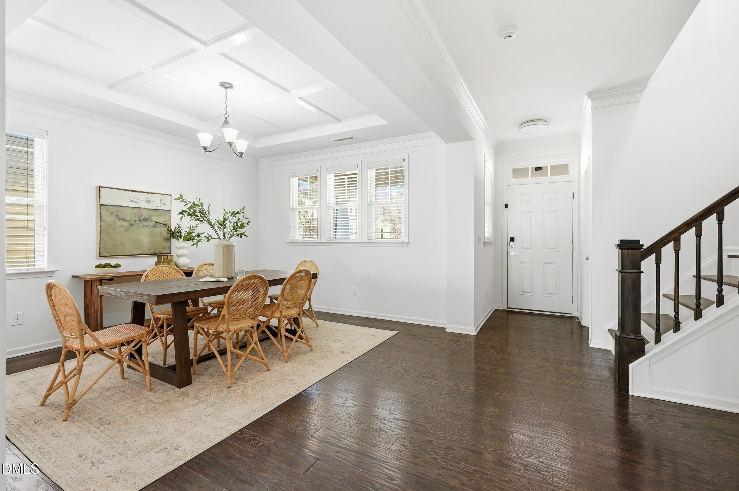 1037 Bender Ridge Drive Morrisville, NC 27560 - Photo 8 of 48 a dining room with wooden floor a chandelier a glass table and chairs