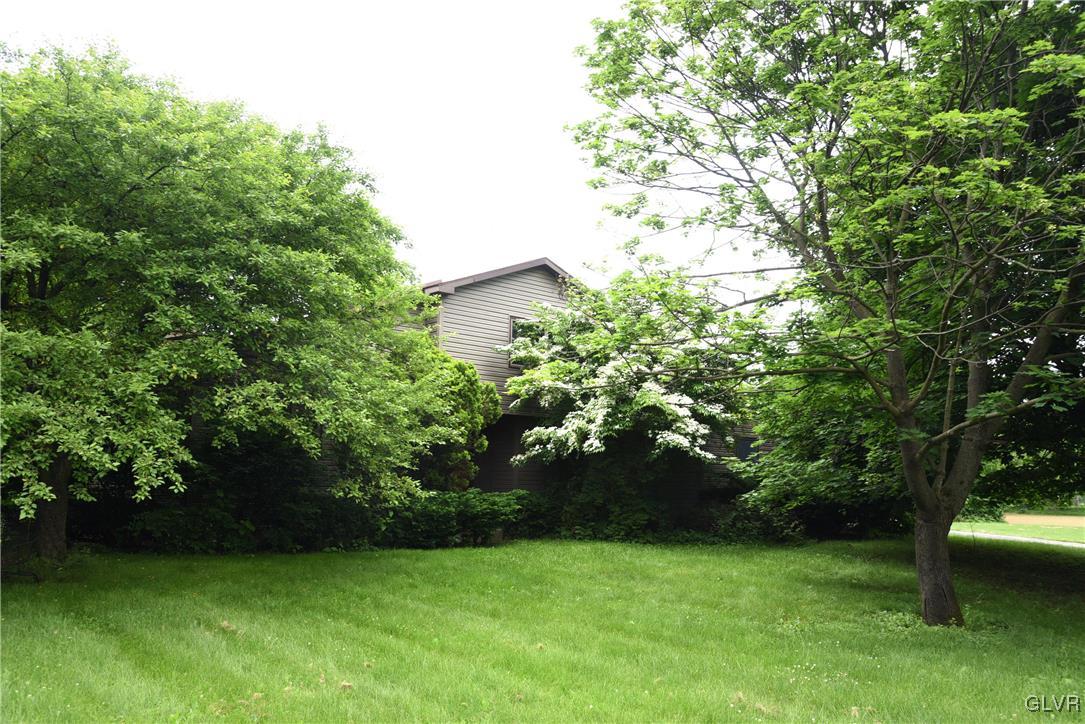 front of home nestled among mature landscaping