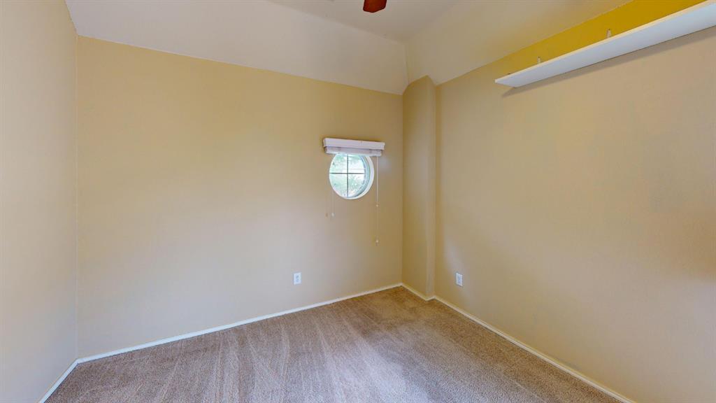 8012 Spring Peaks Drive Plano, TX 75025 - Photo 15 of 21 a view of an empty room with wooden floor and a window