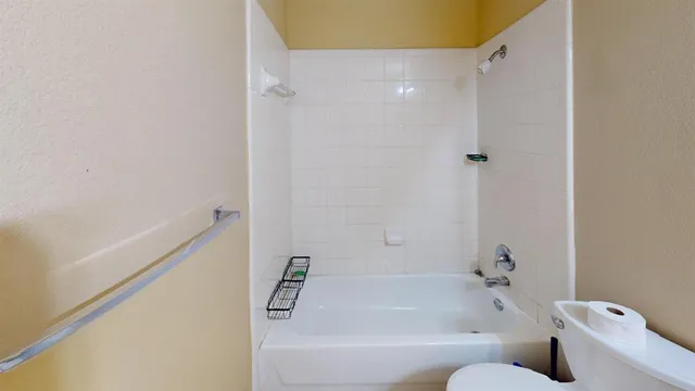 a bathroom with a bathtub and shower