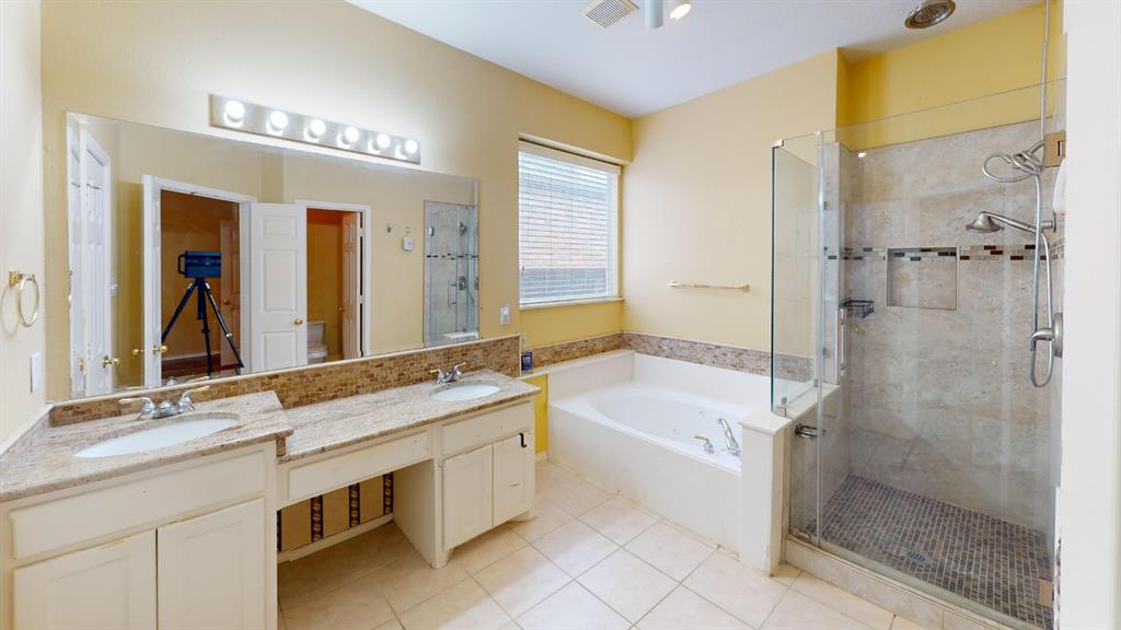 8012 Spring Peaks Drive Plano, TX 75025 - Photo 19 of 21 a bathroom with a granite countertop sink mirror and a bathtub