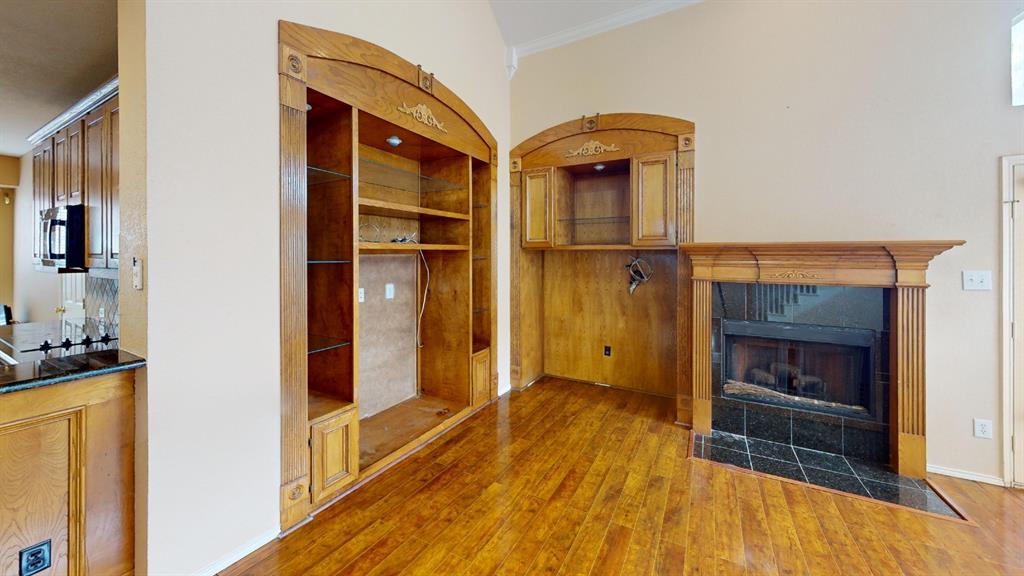 8012 Spring Peaks Drive Plano, TX 75025 - Photo 4 of 21 a view of a hallway with wooden floor and staircase