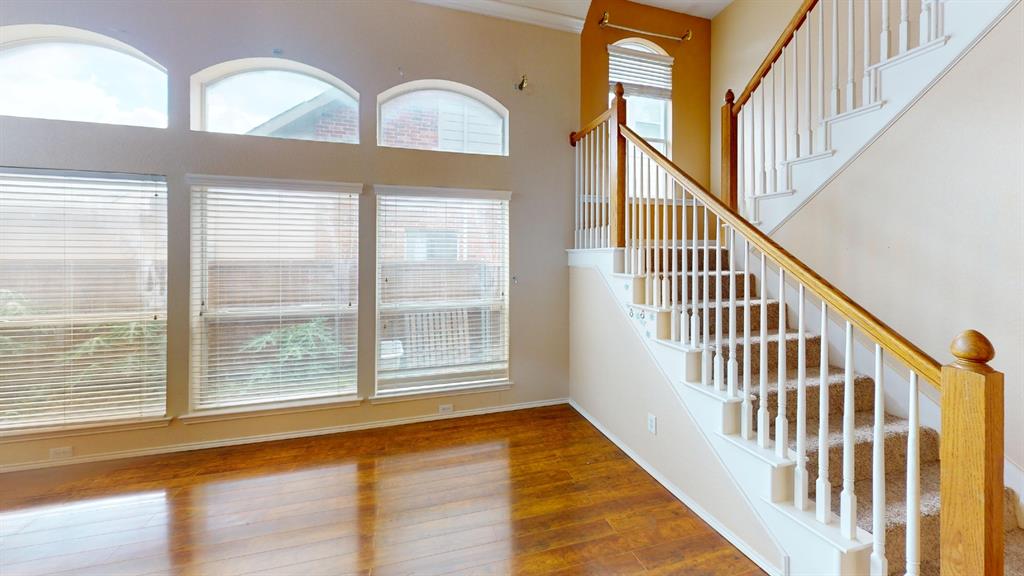 8012 Spring Peaks Drive Plano, TX 75025 - Photo 7 of 21 a view of an entryway with wooden floor