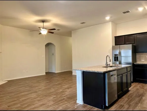 a kitchen with stainless steel appliances granite countertop a sink and stove