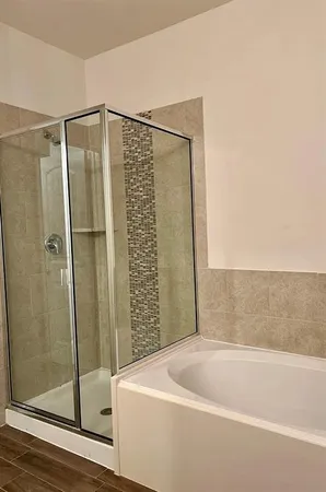 a bathroom with a bathtub and shower