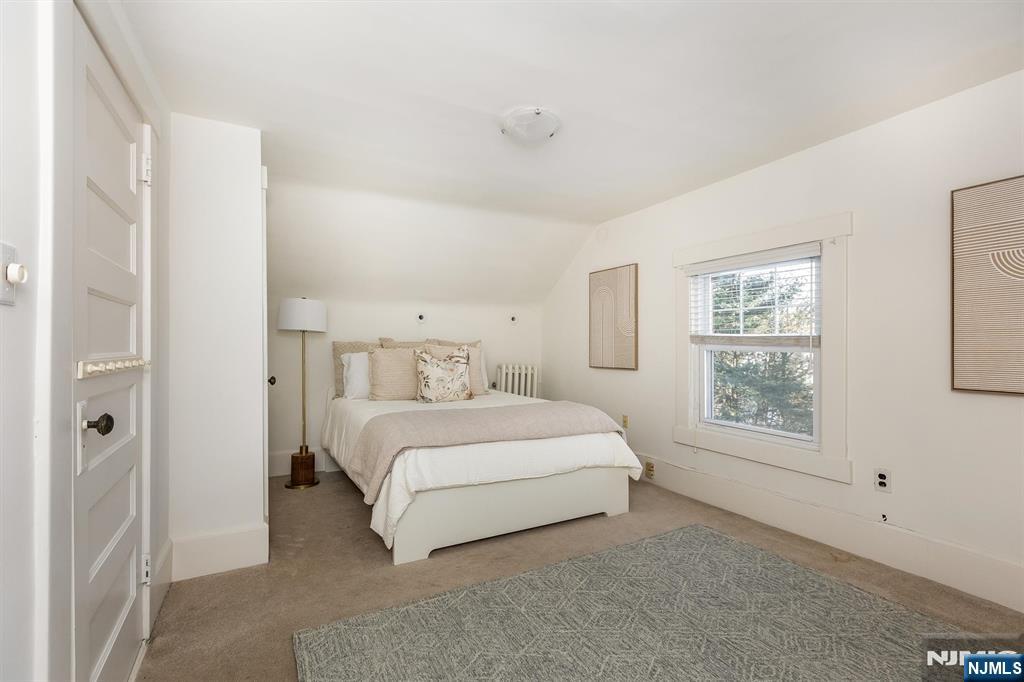 166 Montclair Avenue Montclair, NJ 07042 - Photo 28 of 38 a spacious bedroom with a bed and a window