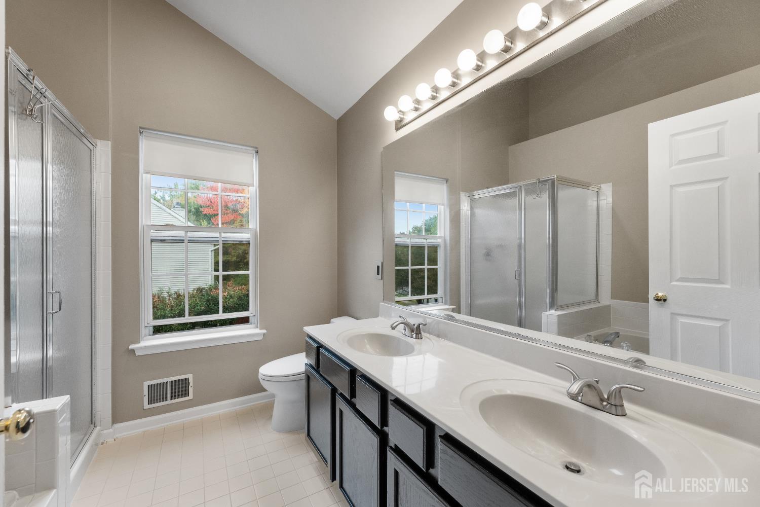2 Rider Terrace Princeton, NJ 08540 - Photo 27 of 40 a bathroom with a double vanity sink a toilet and a large mirror