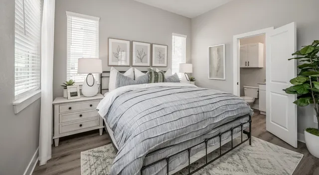 a bedroom with a large bed and a large window