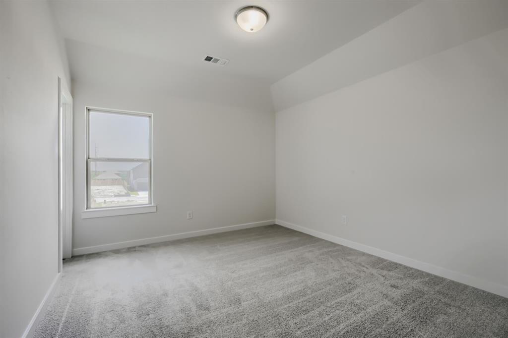 828 Stone Grv Road Lavon, TX 75166 - Photo 15 of 27 Room featuring light gray carpet flooring, white painted walls, and a single window with white trim