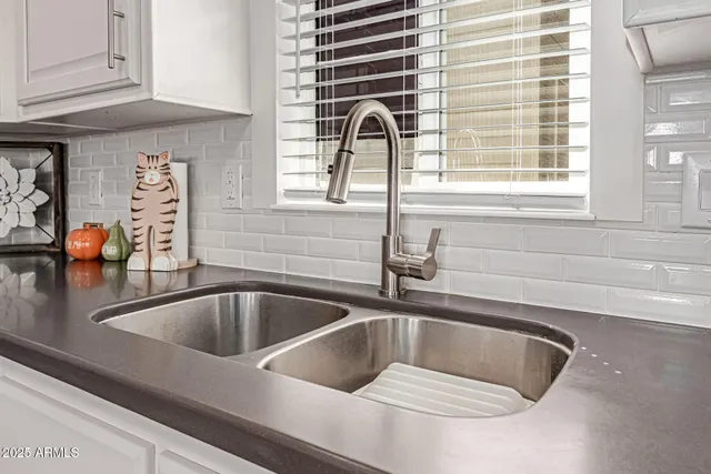 a kitchen with a sink and a window