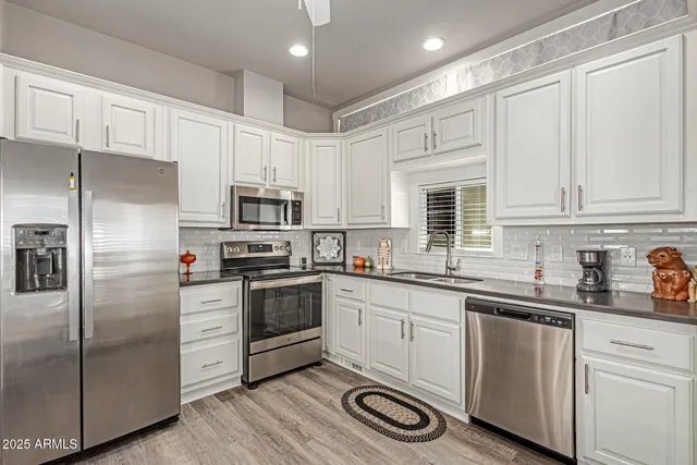 a kitchen with cabinets stainless steel appliances a sink and dishwasher