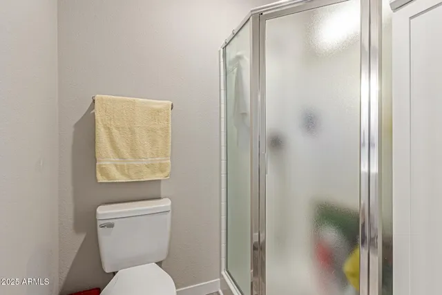 a white toilet sitting next to a bathroom sink