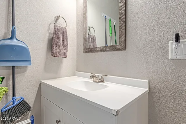a bathroom with a sink vanity and a mirror