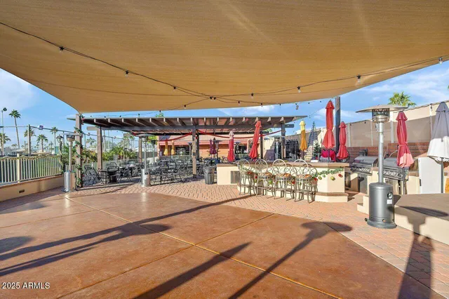 a view of a patio with a table and chairs
