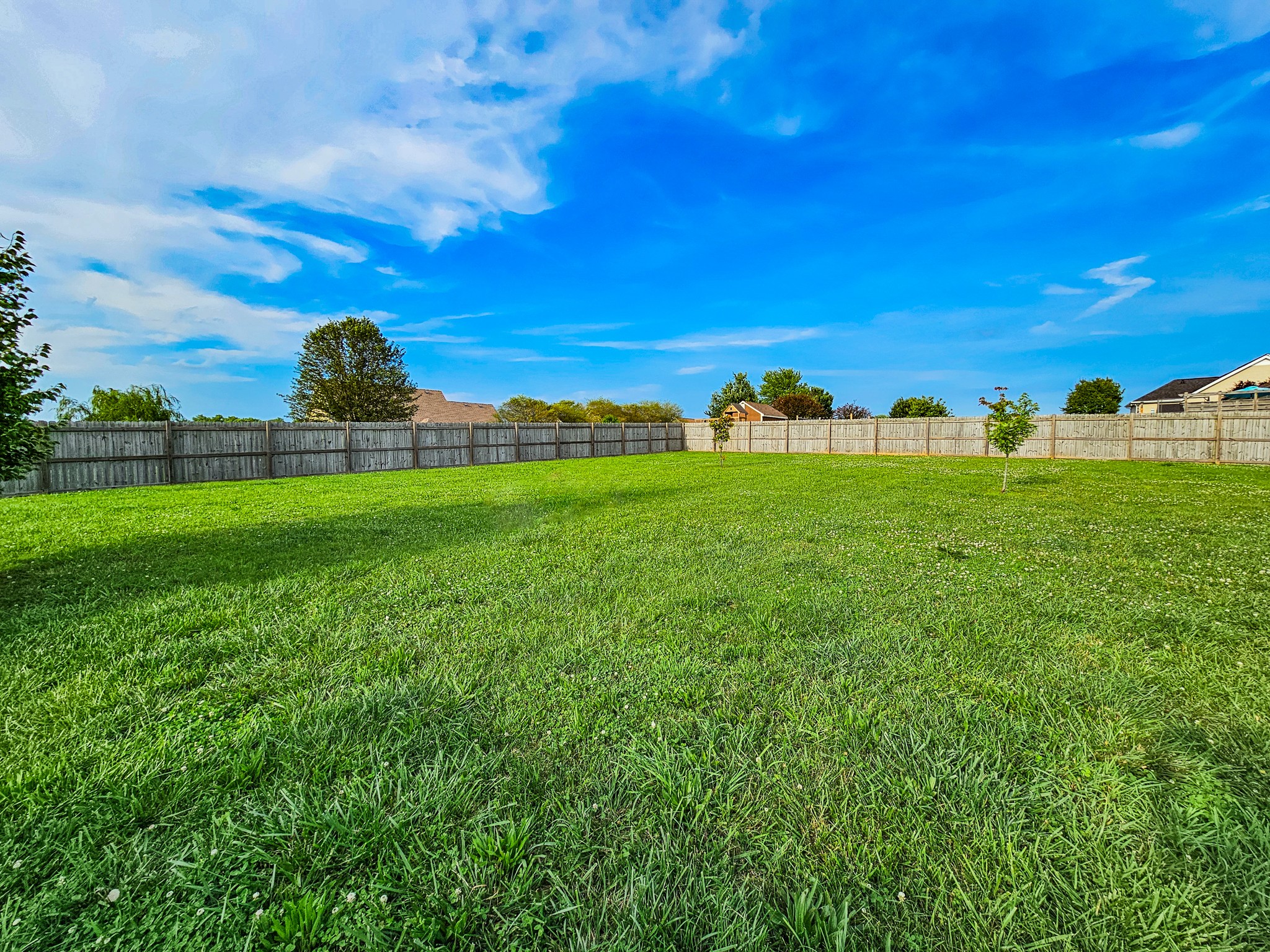 1135 County Line Road Bell Buckle, TN 37020 - Photo 16 of 16 a view of a lush green outdoor space with a swimming pool and valleys in the background