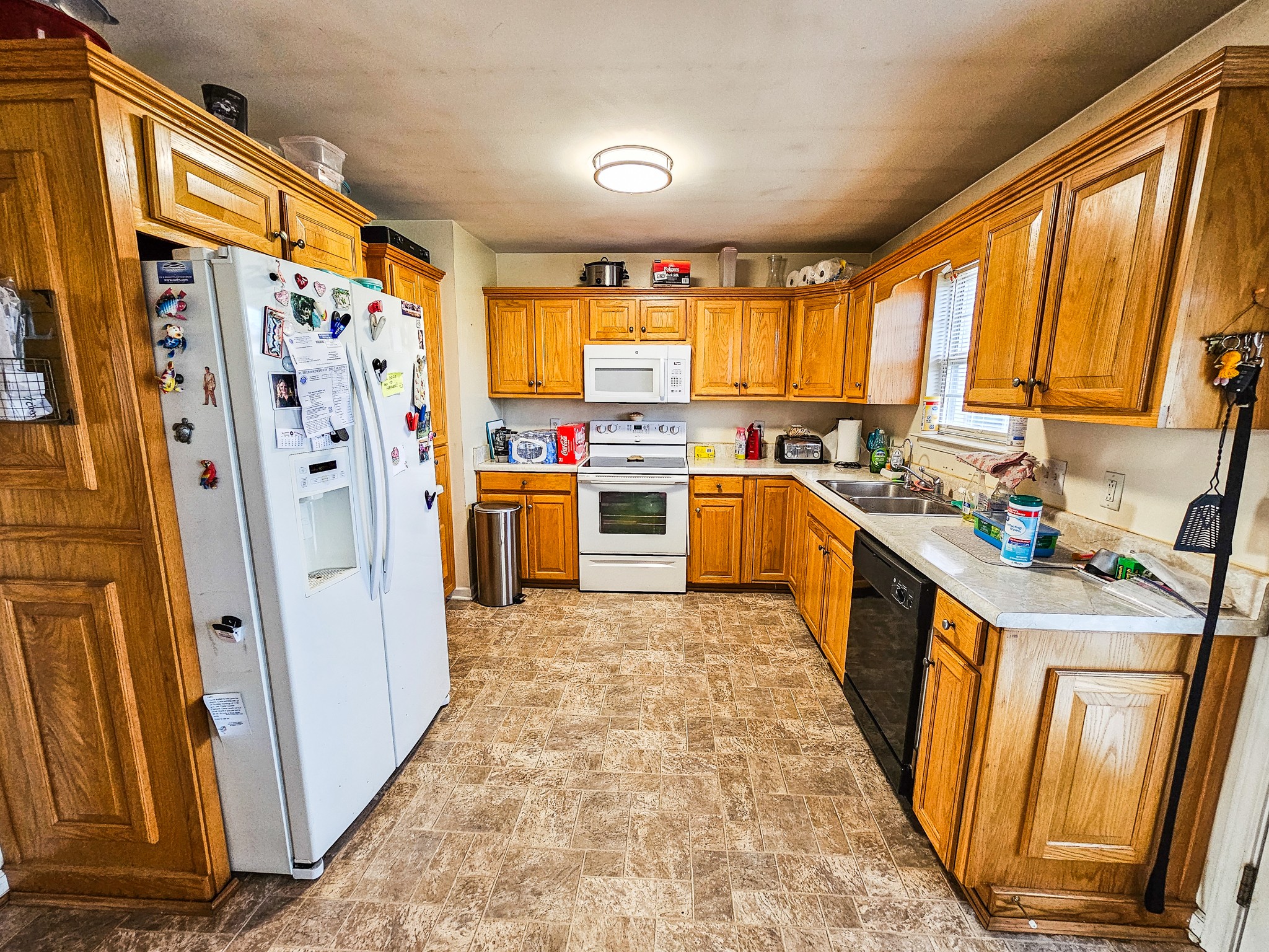 1135 County Line Road Bell Buckle, TN 37020 - Photo 6 of 16 a kitchen with stainless steel appliances granite countertop a refrigerator a stove top oven and a window