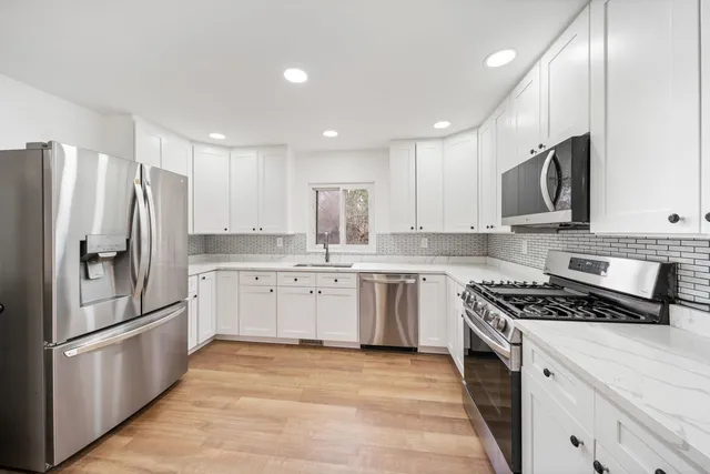 a kitchen with a refrigerator sink and microwave