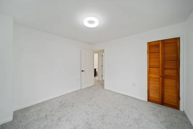 a view of an empty room and closet area