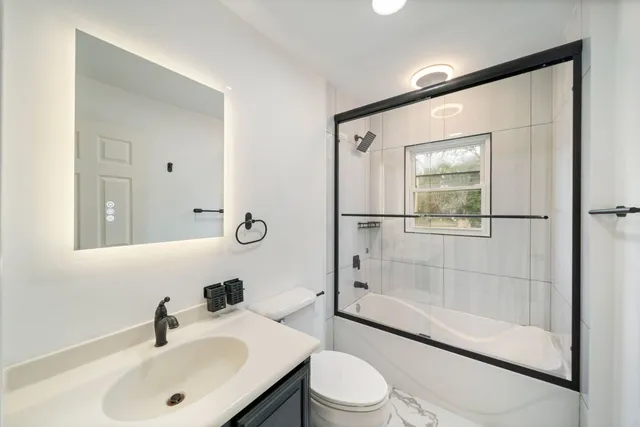 a bathroom with a sink toilet and shower