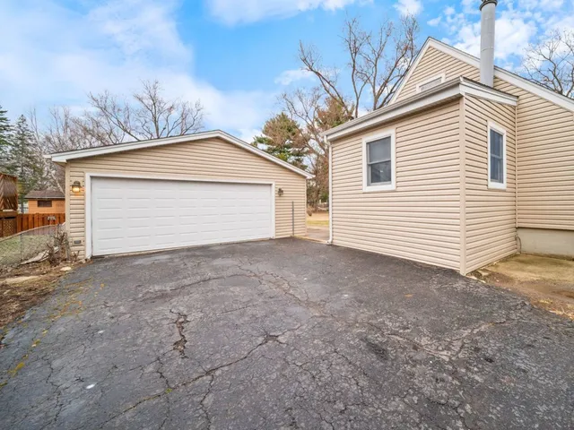 a view of a house with a yard and garage