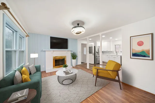 a living room with furniture and a fireplace