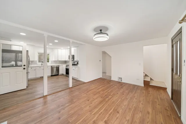 a view of kitchen with wooden floor and electronic appliances