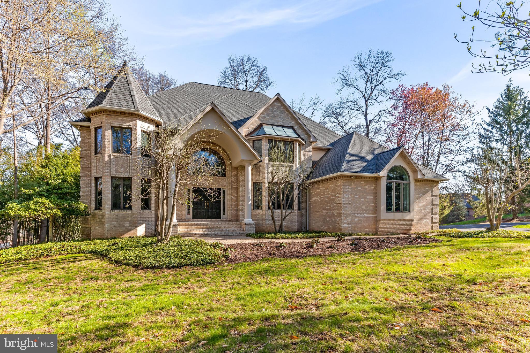 a front view of house with yard and trees around