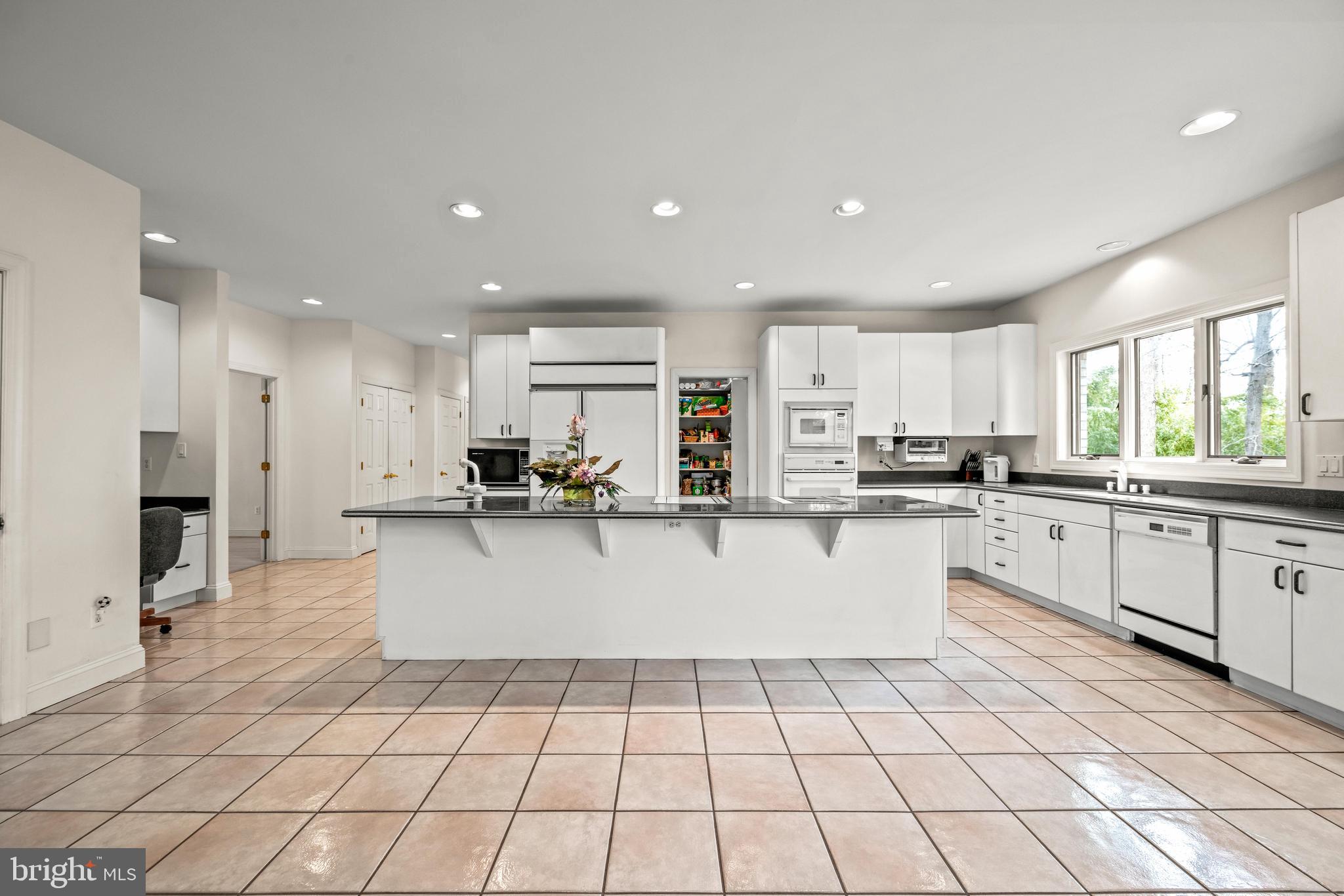 13019 Jerome Jay Drive Cockeysville, MD 21030 - Photo 30 of 61 a large white kitchen with white cabinets and stainless steel appliances