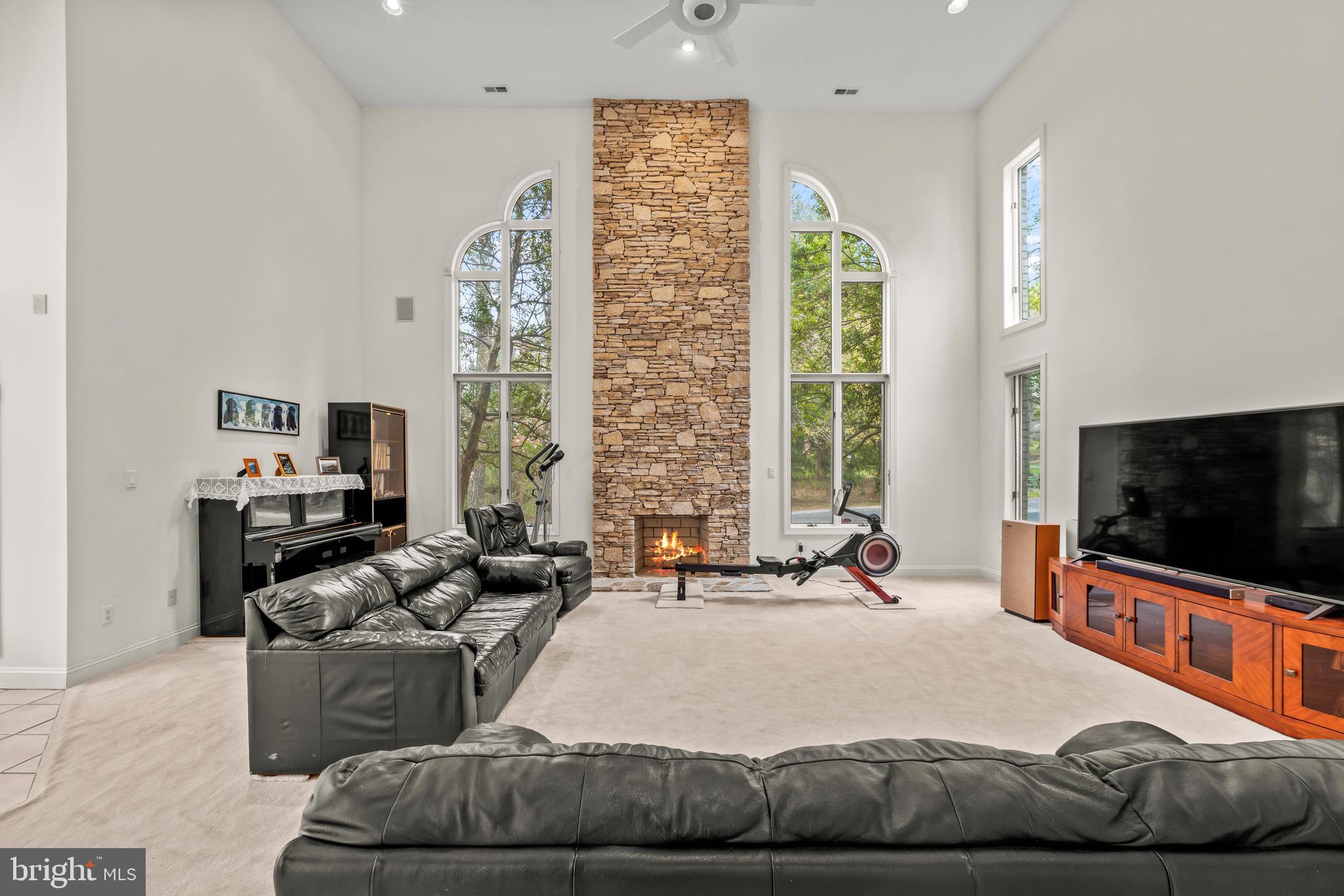 13019 Jerome Jay Drive Cockeysville, MD 21030 - Photo 32 of 61 a living room with furniture a flat screen tv and a large window
