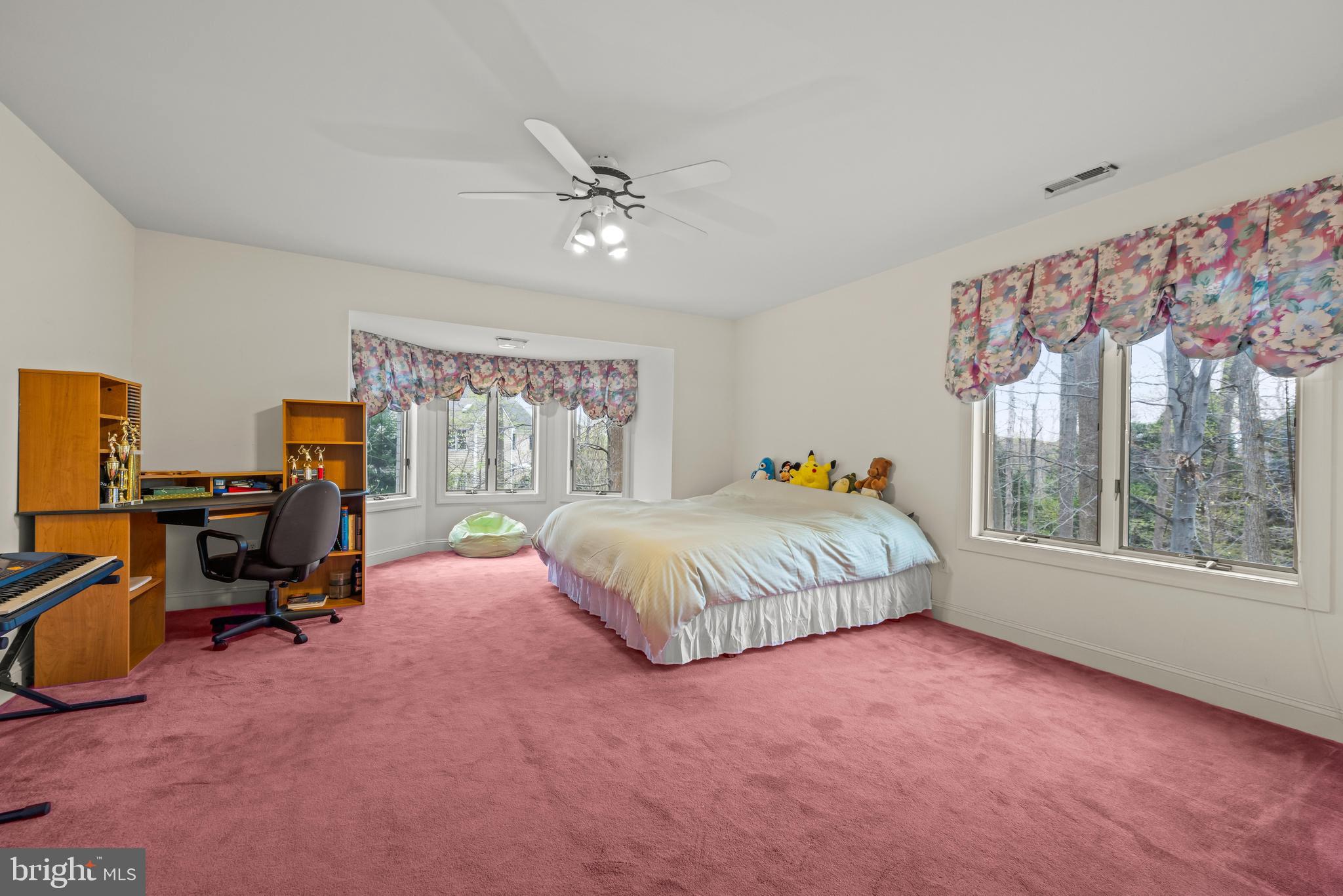 13019 Jerome Jay Drive Cockeysville, MD 21030 - Photo 38 of 61 a spacious bedroom with a bed large window with table and chair