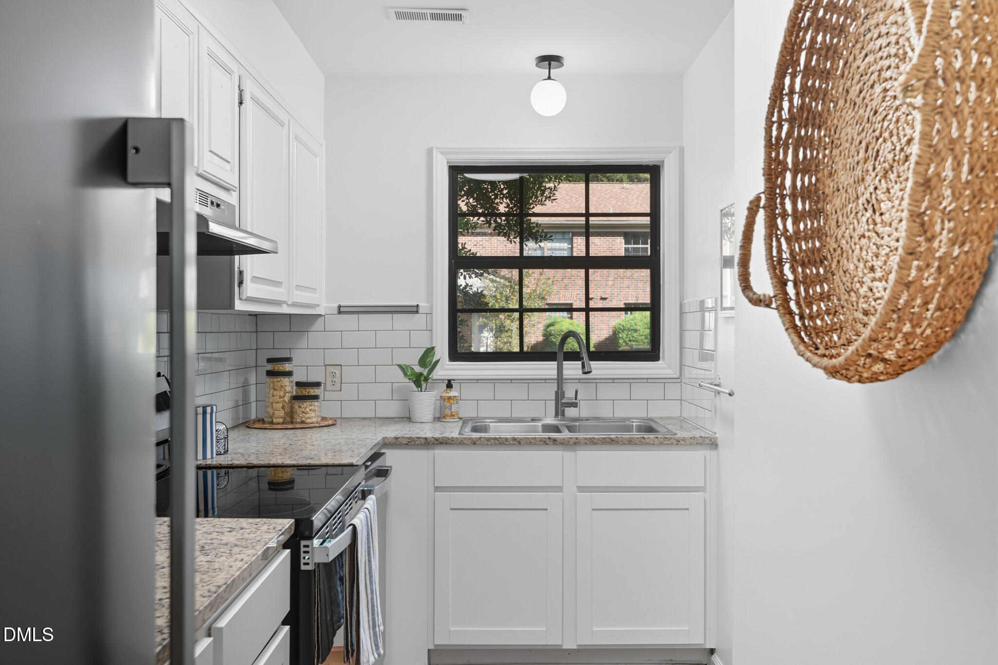 105 Fidelity Street, Unit B9 Carrboro, NC 27510 - Photo 17 of 50 a kitchen with a sink cabinets and a window
