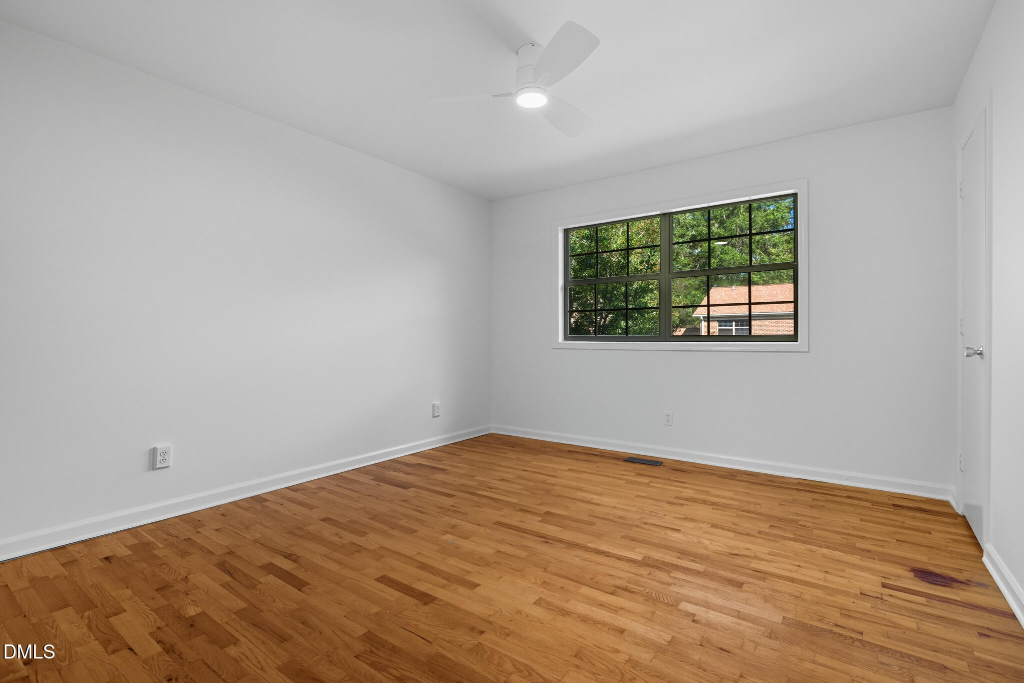 105 Fidelity Street, Unit B9 Carrboro, NC 27510 - Photo 31 of 50 an empty room with wooden floor and windows